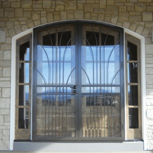 Two black security storm doors with two wooden sidelights for a gray stone-faced home.