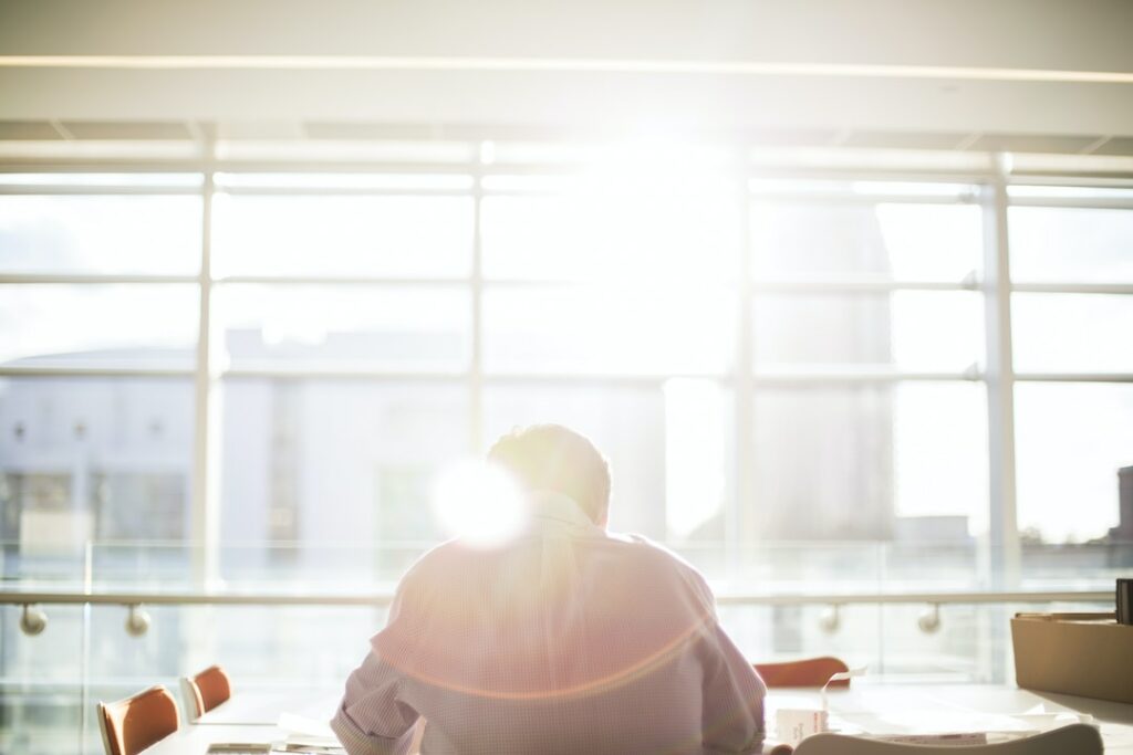 An office building without solar window shades allows UV rays and harsh sunlight into the space.